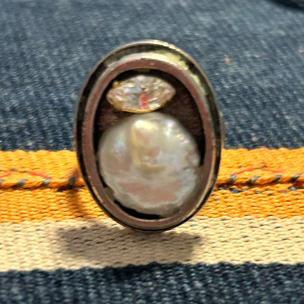 Adjustable rhodium fashion ring with large fresh water pearl and cz.